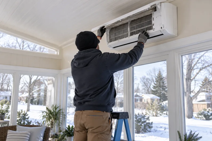 Wall-mounted ductless mini-split head in a finished room